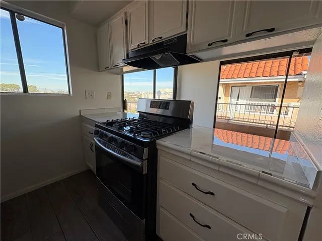a kitchen with stainless steel appliances granite countertop a stove and a microwave
