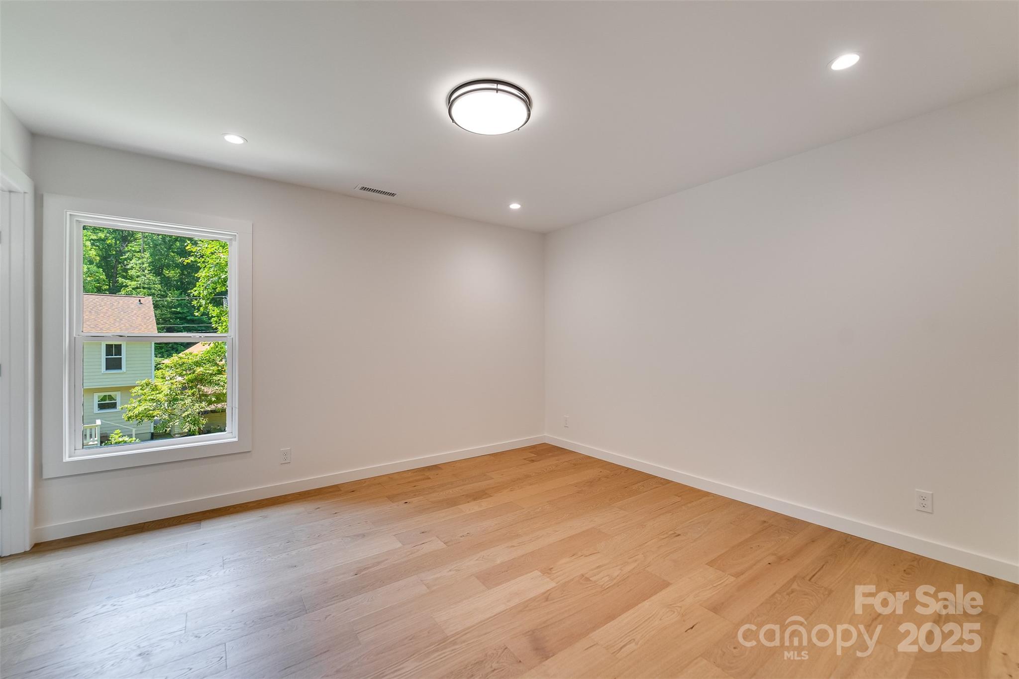 22 Crossing Lane Sylva, NC 28779 - Photo 21 of 44 an empty room with wooden floor and windows
