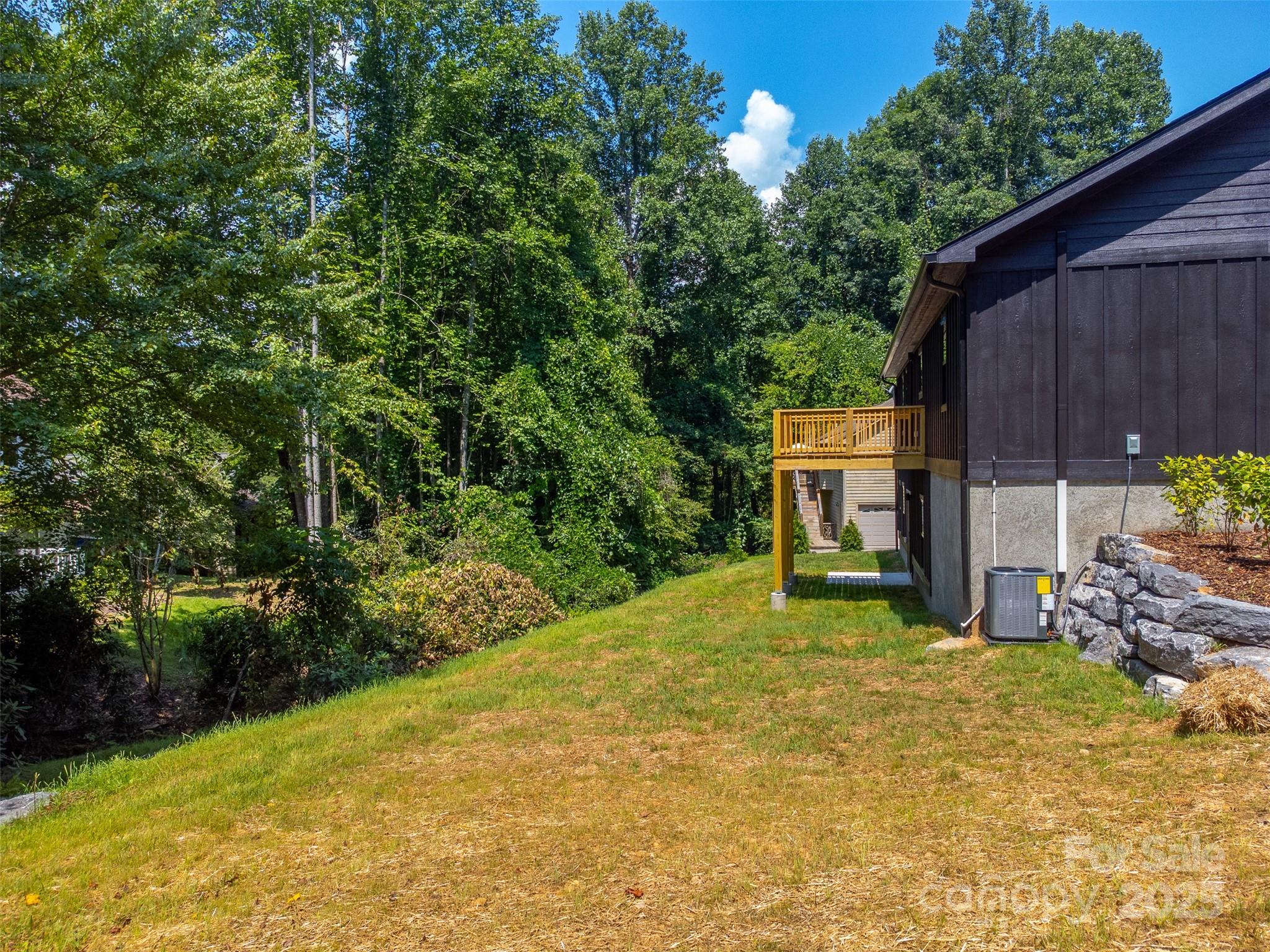22 Crossing Lane Sylva, NC 28779 - Photo 41 of 44 a view of a backyard with table and chairs and potted plants