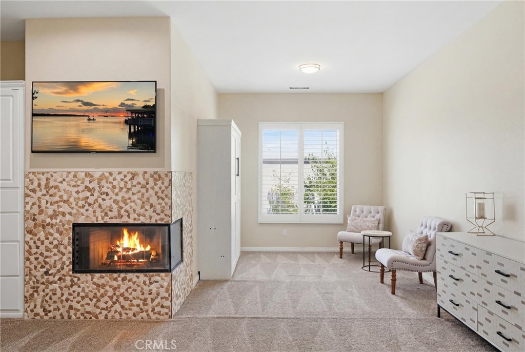 9 Orleans Road Rancho Mirage, CA 92270 - Photo 46 of 71 a living room with furniture a fireplace and a flat screen tv