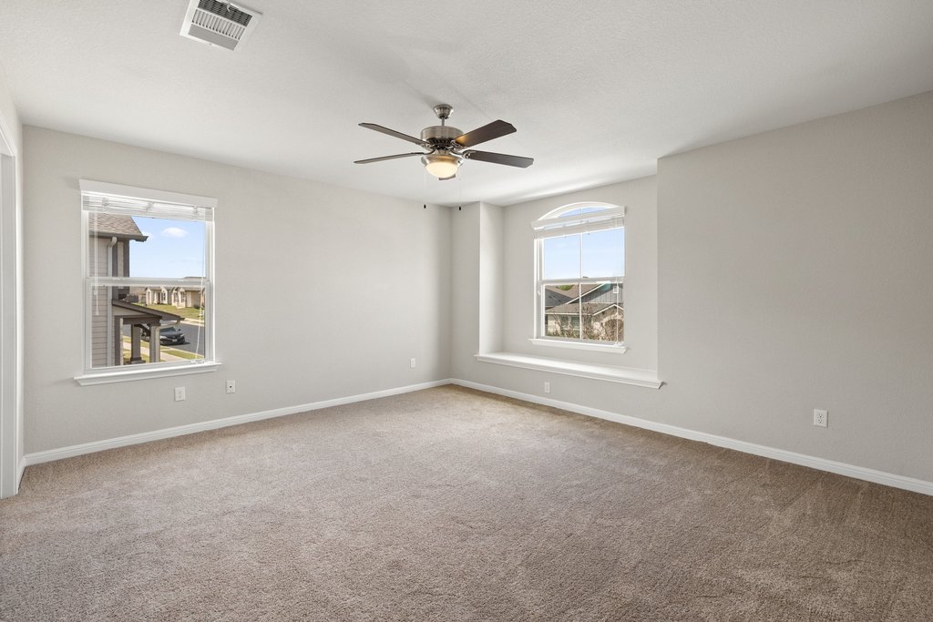 719 Coconut Grove Street Pflugerville, TX 78660 - Photo 17 of 31 an empty room with windows and fan