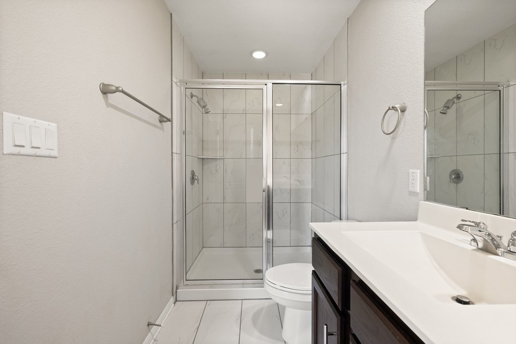 719 Coconut Grove Street Pflugerville, TX 78660 - Photo 20 of 31 a bathroom with a sink a toilet and shower