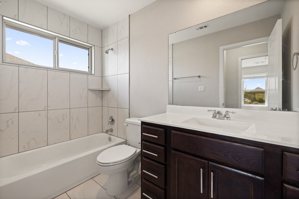 719 Coconut Grove Street Pflugerville, TX 78660 - Photo 25 of 31 a bathroom with a sink a toilet and shower