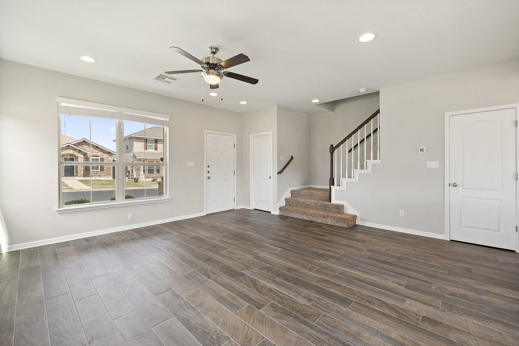 719 Coconut Grove Street Pflugerville, TX 78660 - Photo 7 of 31 a view of an empty room with wooden floor and a window