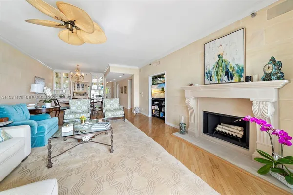 a living room with furniture potted plant and a chandelier