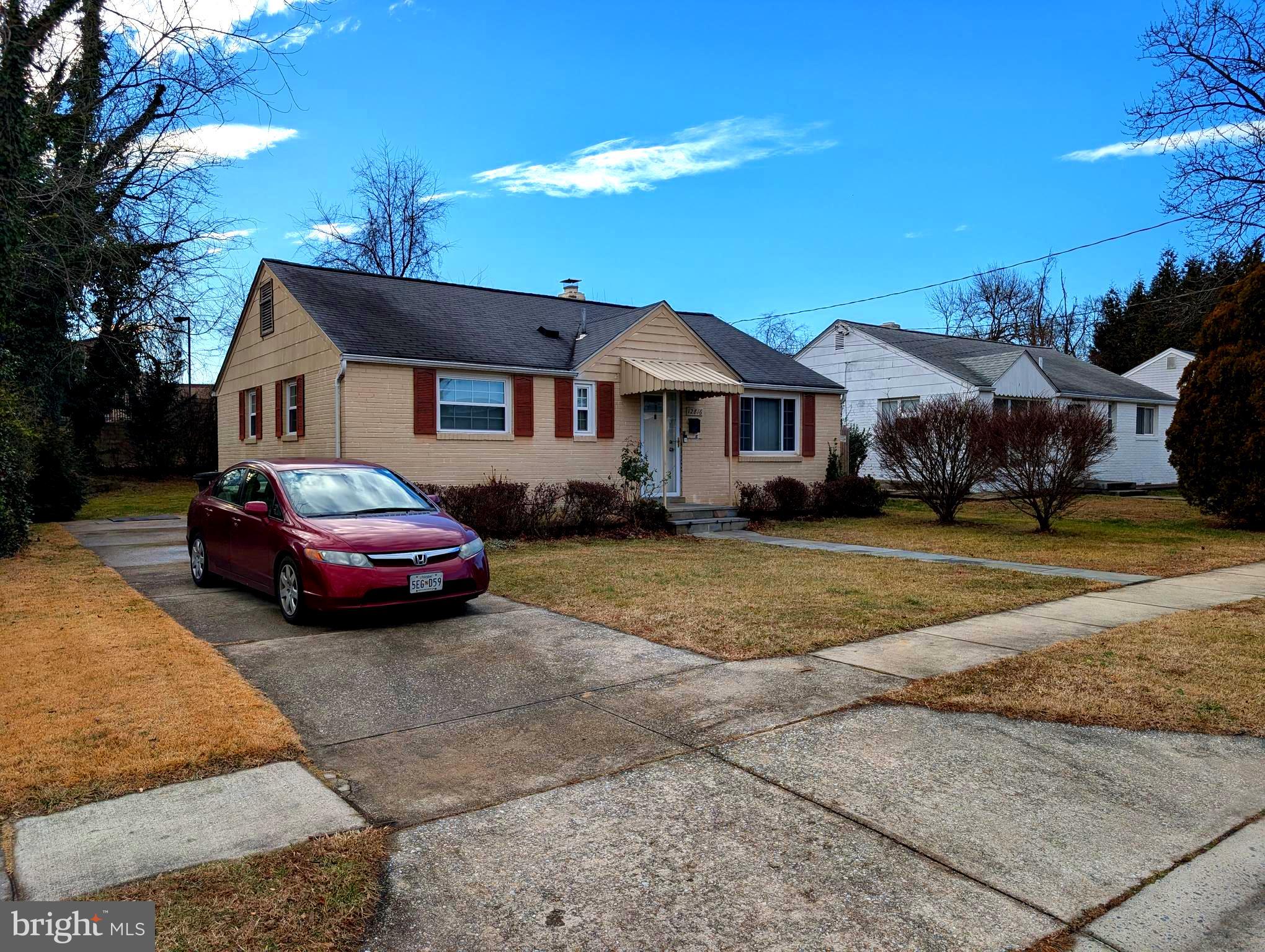 12816 Valleywood Drive Silver Spring, MD 20906 - Photo 3 of 20 a front view of a house with a garden and trees