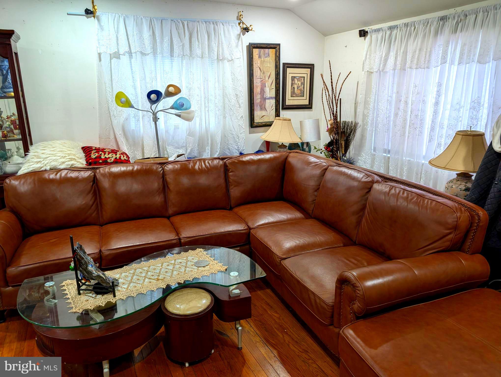 12816 Valleywood Drive Silver Spring, MD 20906 - Photo 4 of 20 a blue couch sitting in a living room next to a window