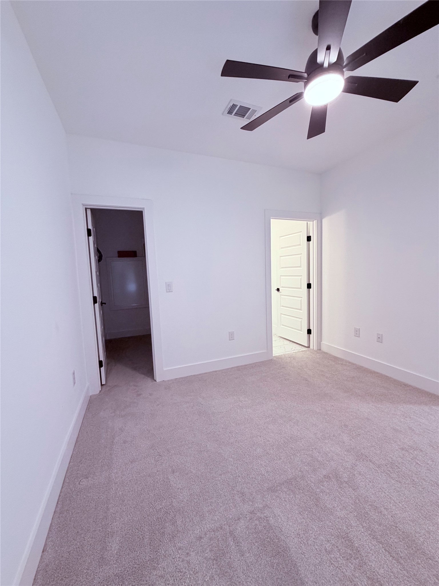 1417 Kramer Lane, Unit 7 Austin, TX 78758 - Photo 18 of 24 A well-lit bedroom with fresh carpeting and a modern ceiling fan, ready for personal touches.