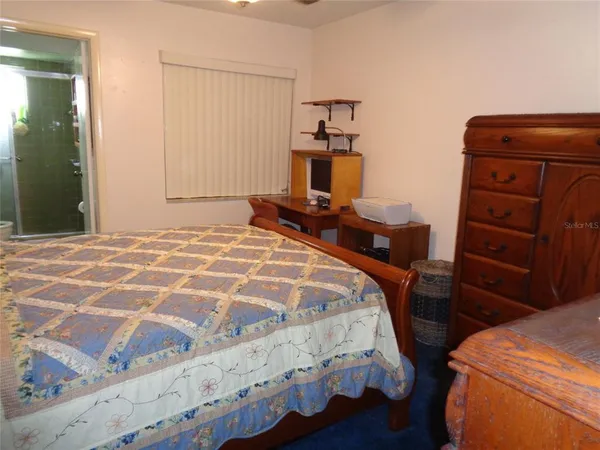 a bedroom with a bed and a mirror