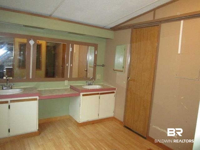 20705 Greek Cemetery Road Robertsdale, AL 36567 - Photo 14 of 25 Full bathroom featuring light wood-style floors and double vanity