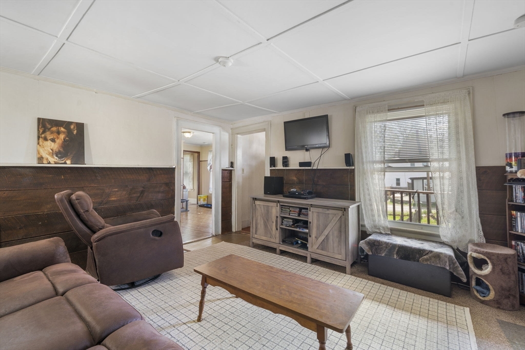 17-19 Whitehall Road Amesbury, MA 01913 - Photo 15 of 37 a living room with furniture a flat screen tv and a window