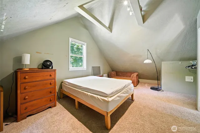 a bed room with a bed and a dresser