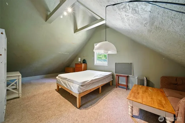 a room with a bed and a chandelier