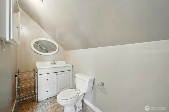 a bathroom with a toilet a sink and a mirror