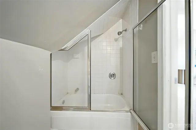 a bathroom with a glass shower door