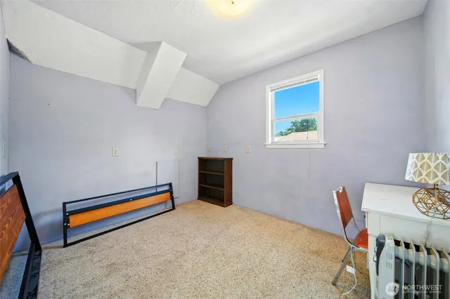 a bed room with furniture and a chair