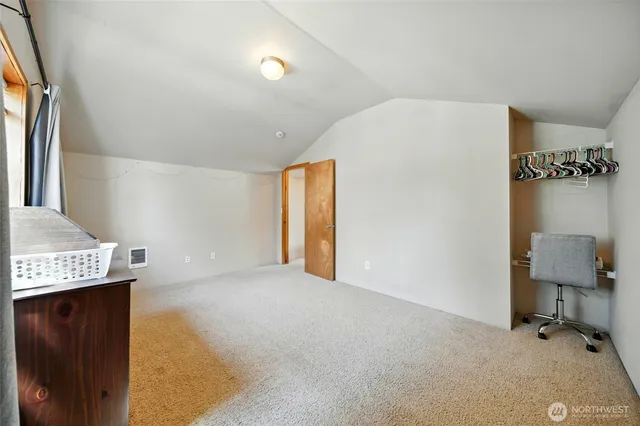 a view of a patio with table and chairs and floor to ceiling window