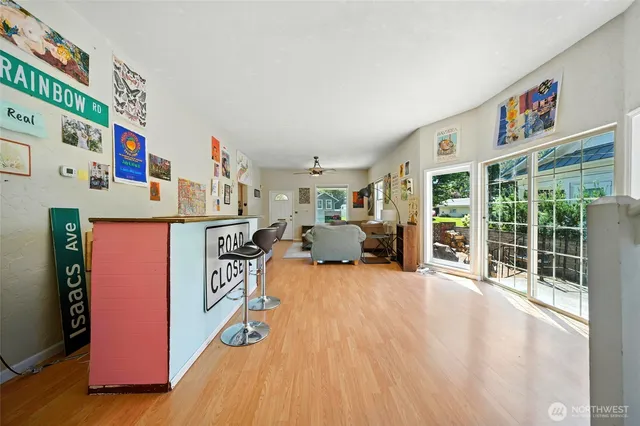a very nice looking living room with a large window and a wooden floor