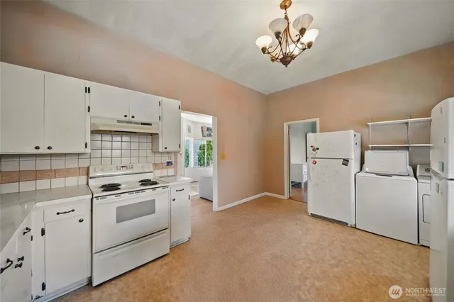 a kitchen with cabinets and white appliances