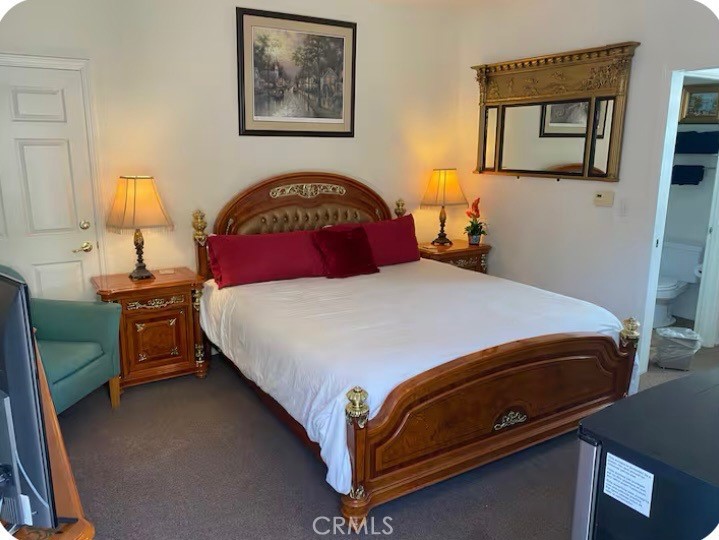 444 Pier Avenue, Unit 36 Oceano, CA 93445 - Photo 2 of 7 a bedroom with a bed and a painting on the wall