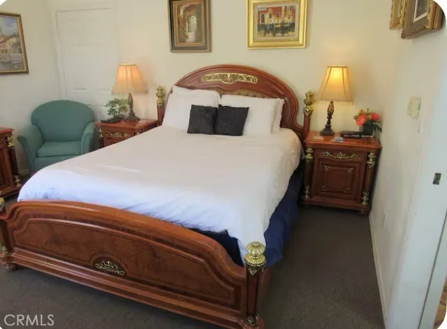 a bedroom with a bed and a lamp on table