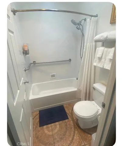 a bathroom with a toilet and a shower
