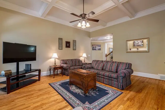 a spacious bedroom with a bed and a chandelier