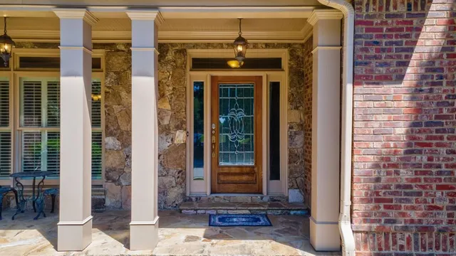 a view of a dining room with furniture and chandelier