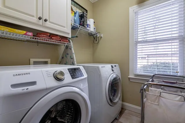 a view of a hallway with wooden floor and a bathroom