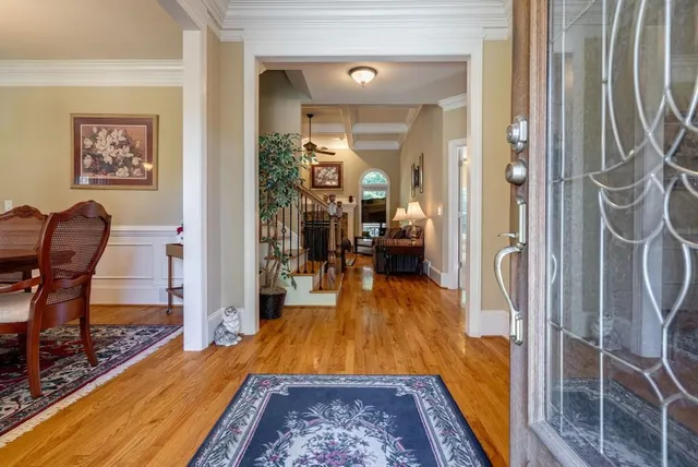 a dining room with furniture a chandelier and wooden floor