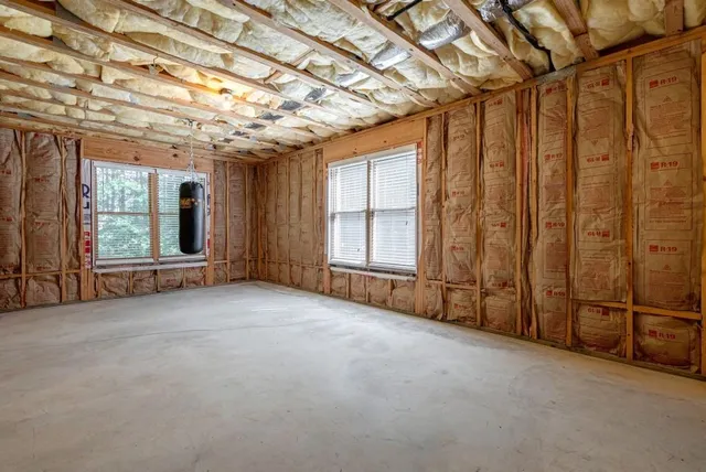 a view of a balcony with floor to ceiling window next to a yard