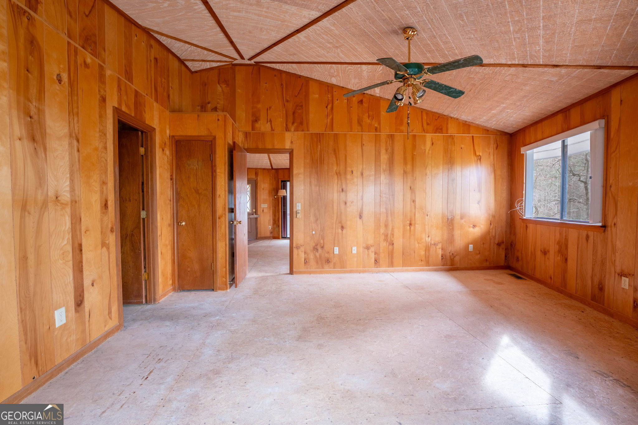159 Clare Lane Rabun Gap, GA 30568 - Photo 15 of 41 an empty room with a ceiling fan and windows