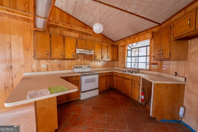 a view of empty room with fireplace and windows