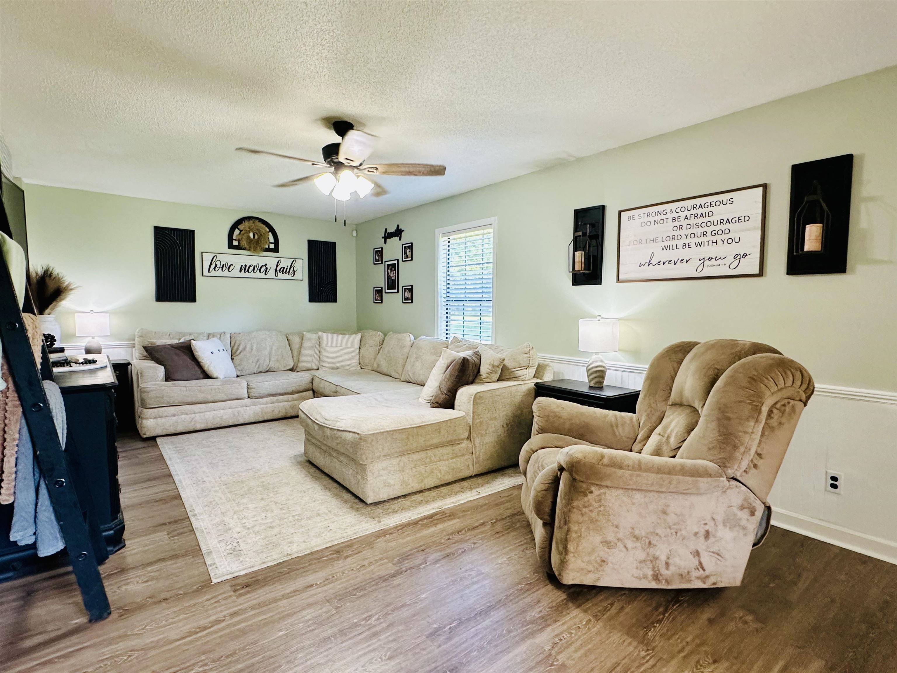 7120 Powell Chapel Road Hornsby, TN 38044 - Photo 2 of 29 a living room with fireplace furniture and a wooden floor