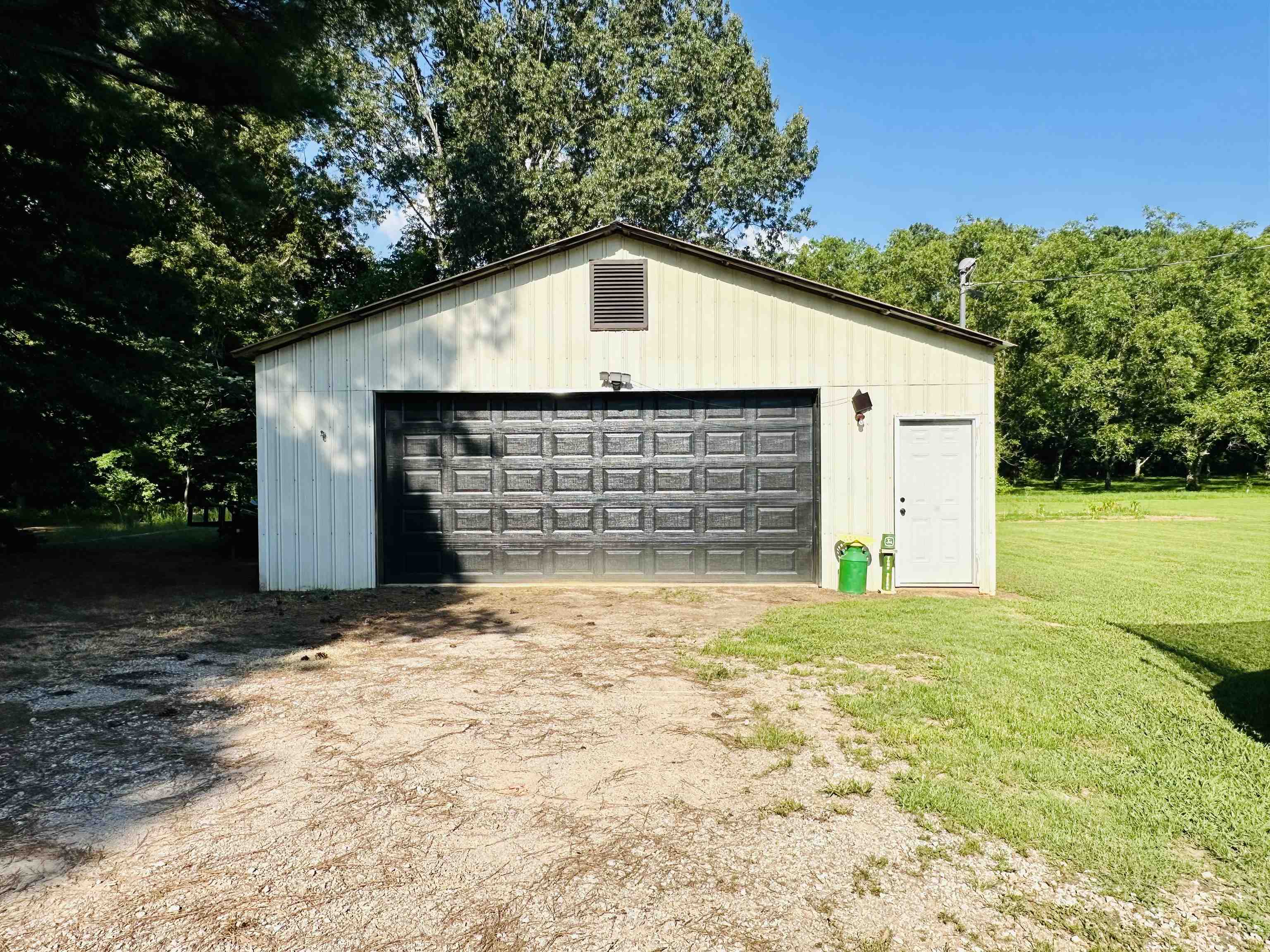 7120 Powell Chapel Road Hornsby, TN 38044 - Photo 22 of 29 a view of large house with a yard and garage