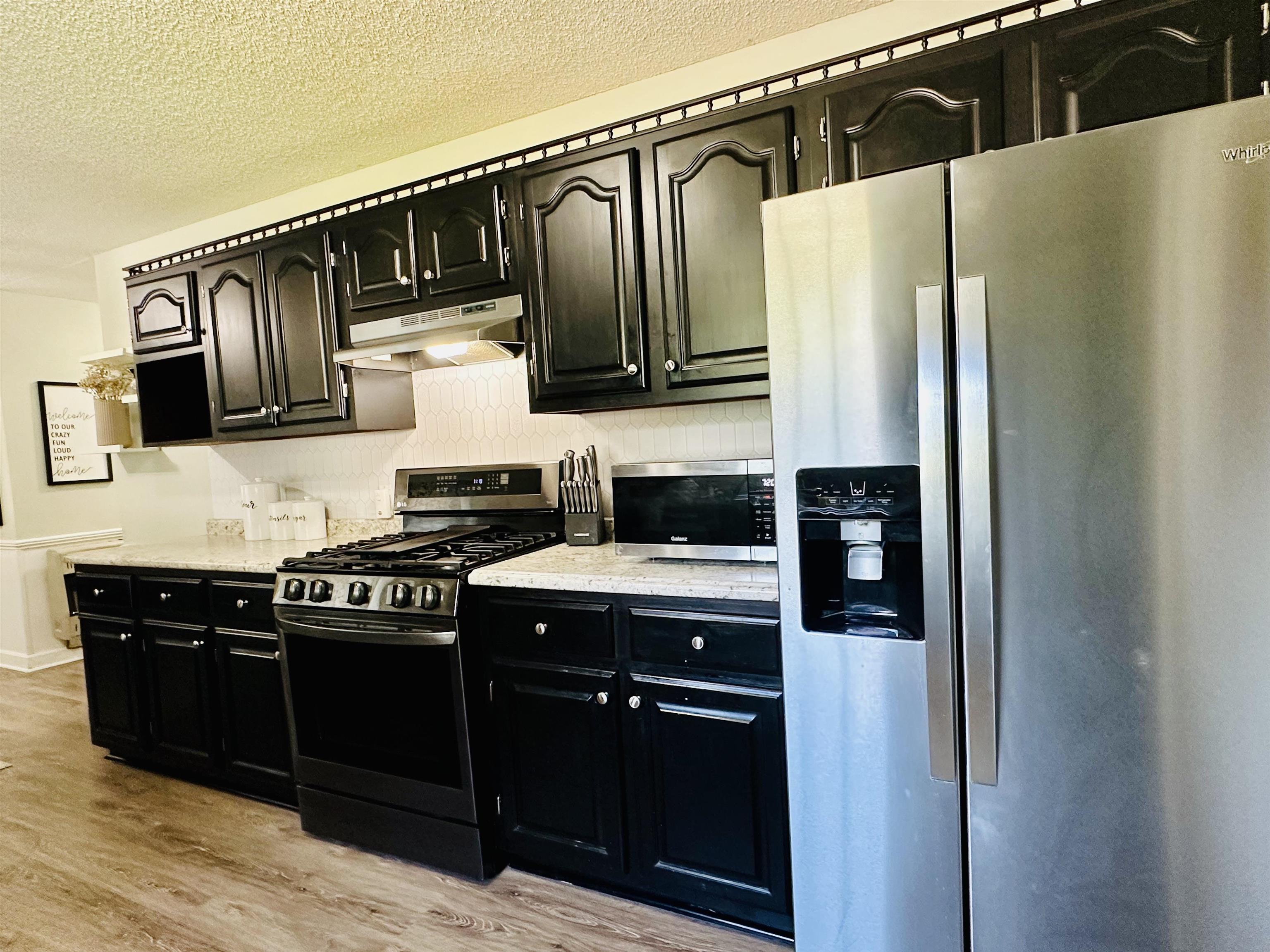 7120 Powell Chapel Road Hornsby, TN 38044 - Photo 9 of 29 a kitchen with a refrigerator and a sink