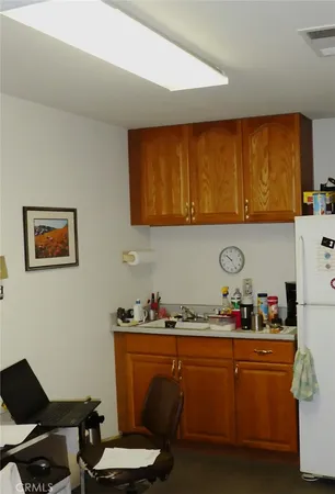 a room with granite countertop cabinets and chair