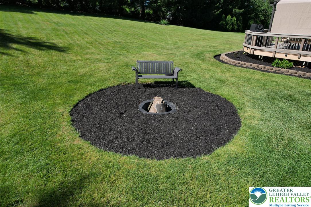 3470 Brodhead Road Bethlehem, PA 18020 - Photo 25 of 84 A sprawling green lawn features a neatly mulched fire pit area, ideal for evening gatherings.