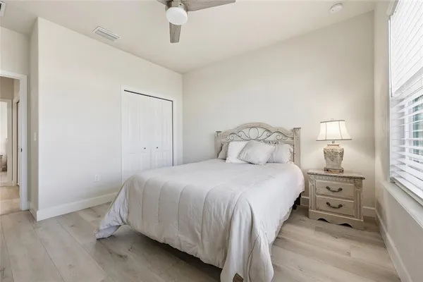 a bedroom with a bed and a window