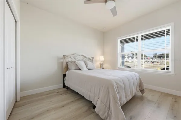 a bedroom with a bed and a large window