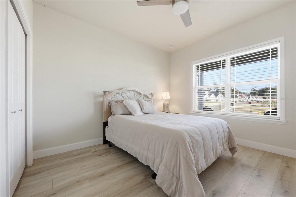 1402 Southwest 67th Drive Gainesville, FL 32607 - Photo 17 of 30 a bedroom with a bed and a large window