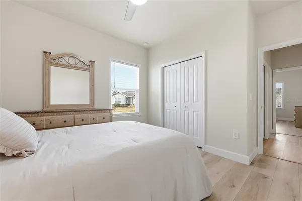 a bedroom with a bed and a mirror