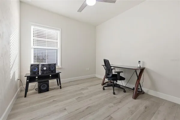 a view of a workspace with furniture and a window