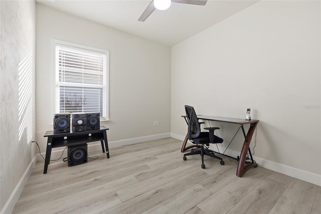 1402 Southwest 67th Drive Gainesville, FL 32607 - Photo 19 of 30 a view of a workspace with furniture and a window