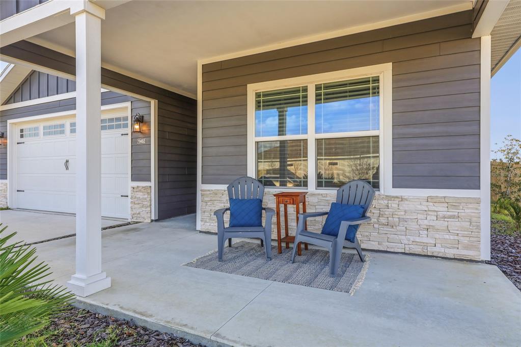 1402 Southwest 67th Drive Gainesville, FL 32607 - Photo 23 of 30 a patio with table and chairs and potted plants