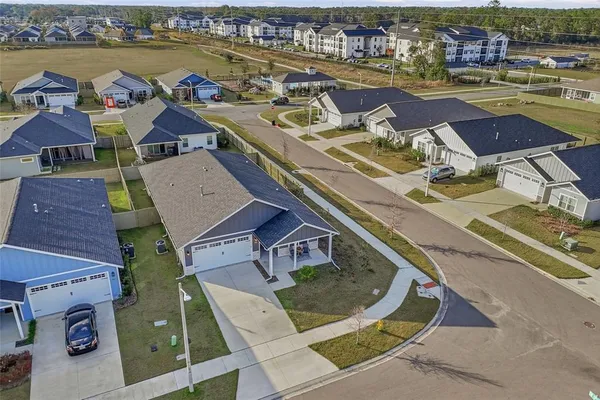 an aerial view of residential houses with outdoor space