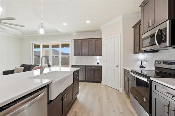 a kitchen with stainless steel appliances granite countertop a sink stove and refrigerator
