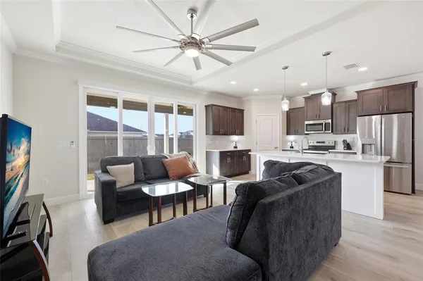 a living room with stainless steel appliances kitchen island granite countertop furniture and a kitchen view