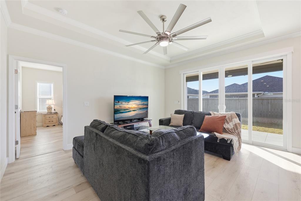 1402 Southwest 67th Drive Gainesville, FL 32607 - Photo 9 of 30 a living room with furniture and a flat screen tv