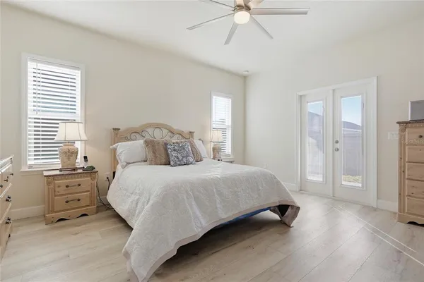 a bedroom with a bed and a chandelier